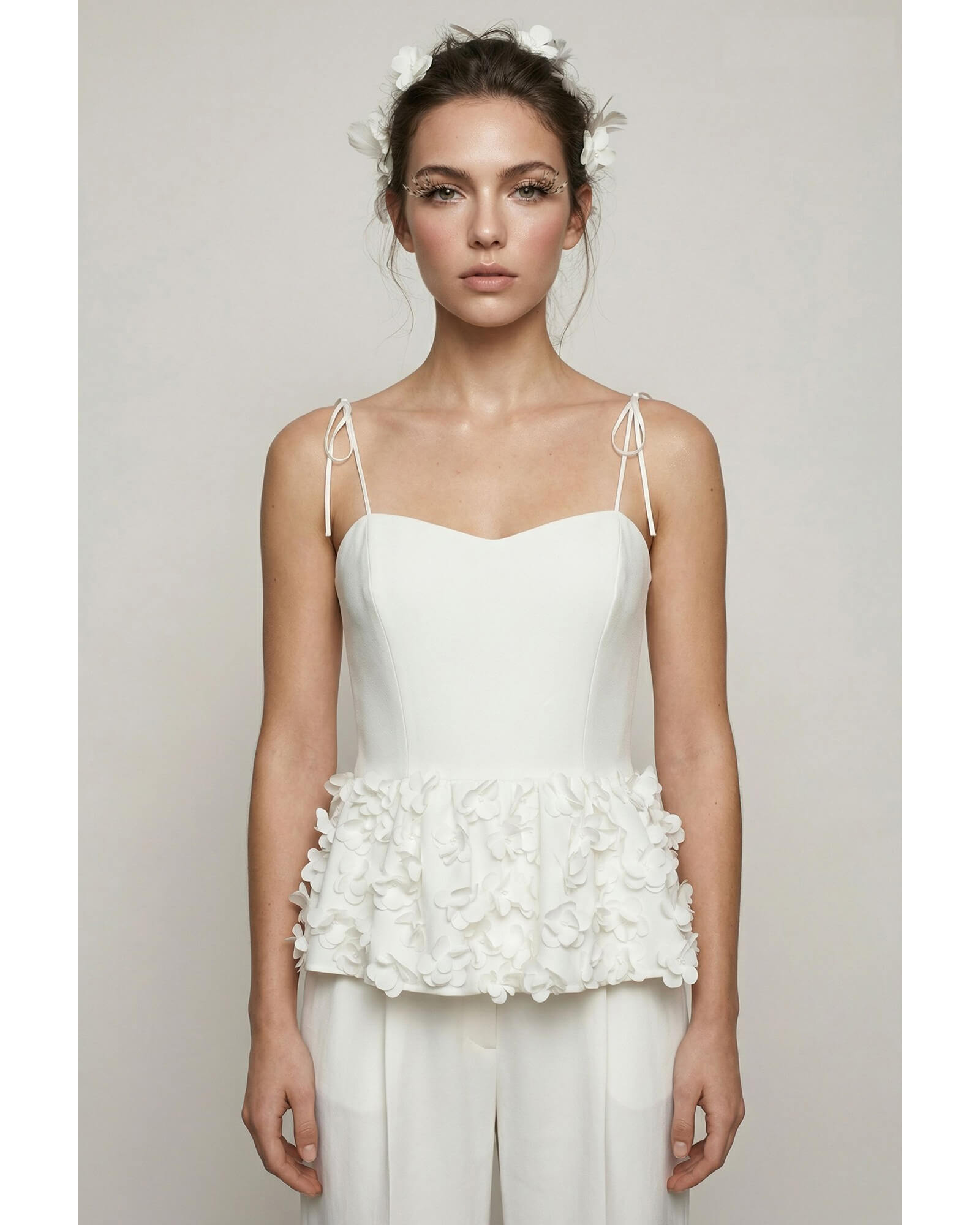 Hand-embellished white crepe peplum top with floral appliqués and tie straps