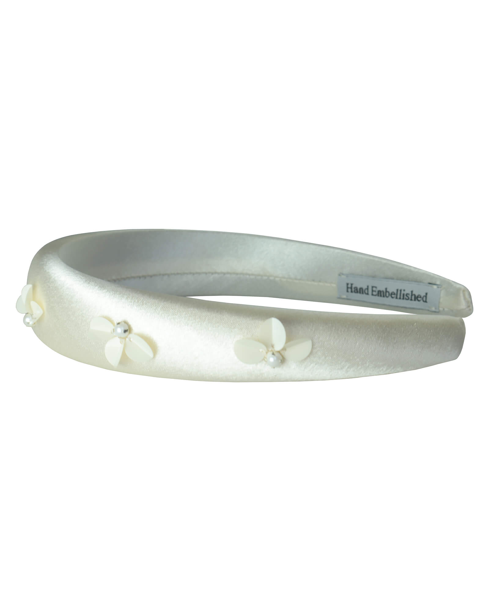 Luxurious ivory satin padded headband, hand-embellished with dimensional sequin flowers and silver-capped pearls. Front three-quarter view showing the intricate craftsmanship and comfort padding.